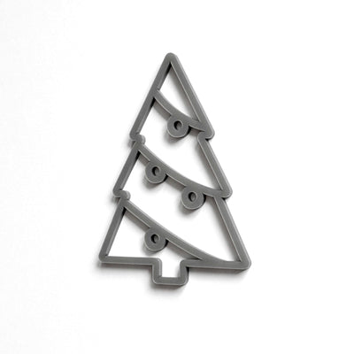 A simple, stylized Christmas tree cookie cutter in a gray color.