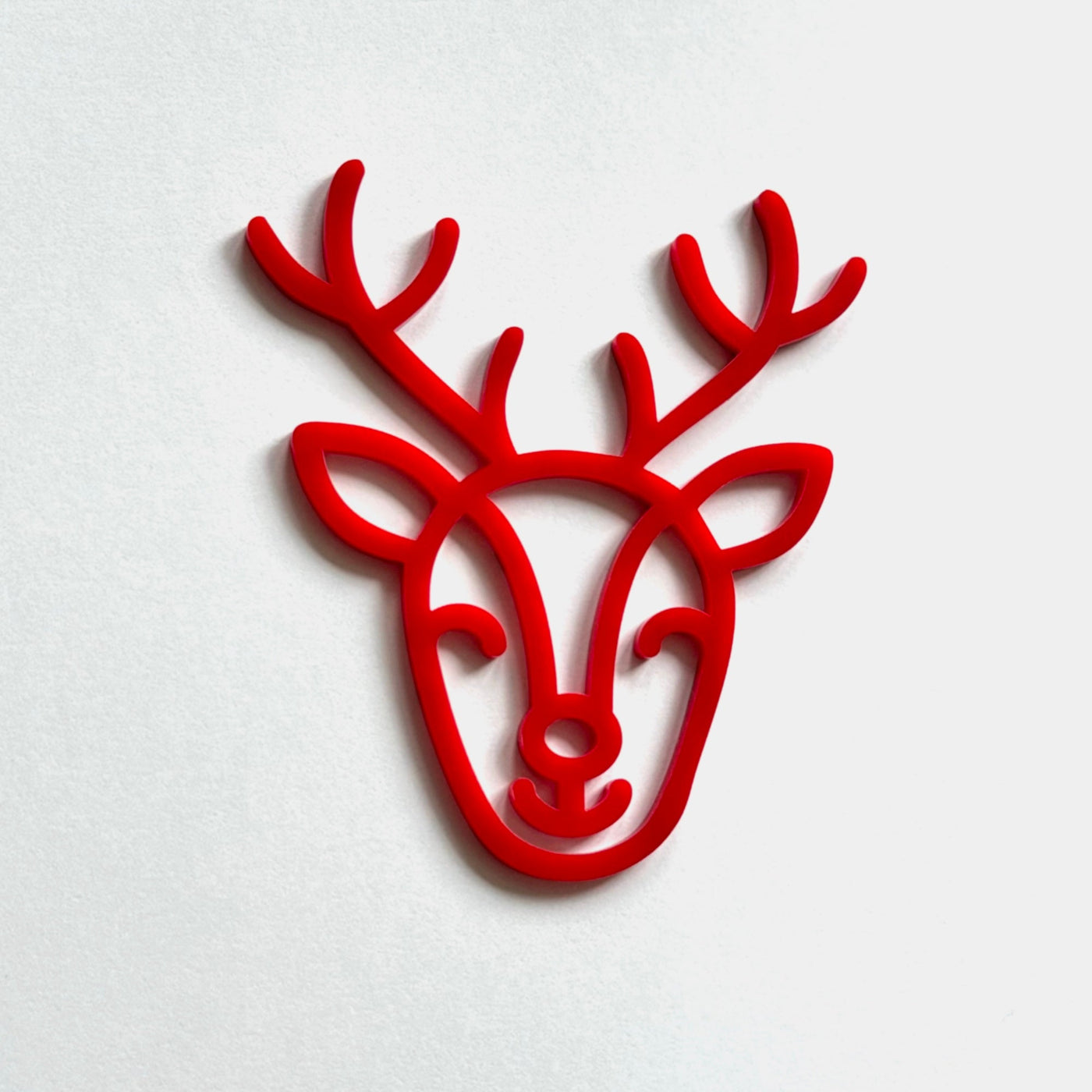 A red stylized deer head with antlers is displayed against a white background.