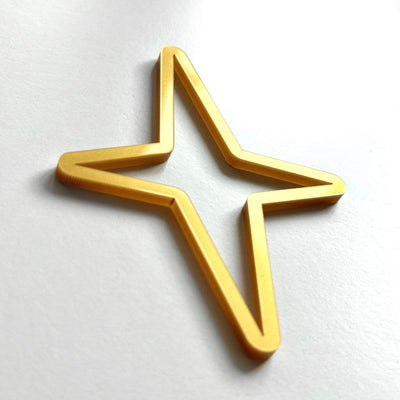 A golden star-shaped object is shown against a white background.