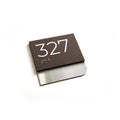 a dark brown rectangular sign with the number "327" printed on it, placed on a white background. - Photo #8