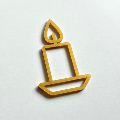 A simple gold candle icon on a white background.