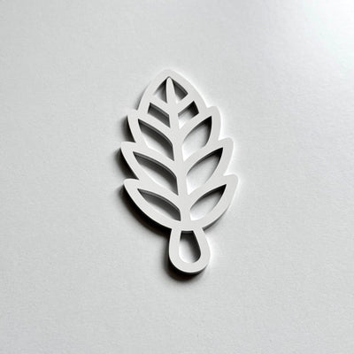 A white leaf-shaped object with a simple, minimalist design.