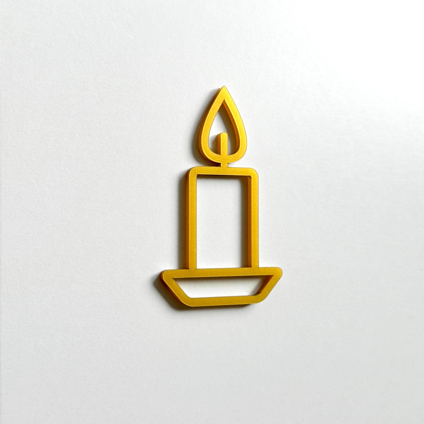 A simple gold candle icon is displayed against a white background.