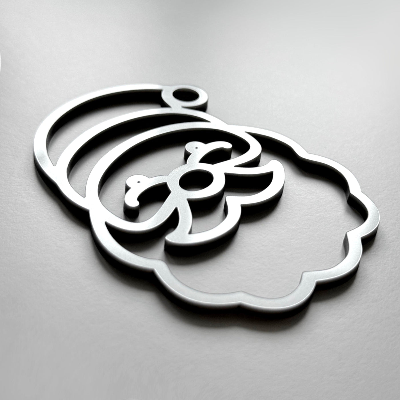 A stylized silhouette of a face or head, resembling a cartoon or abstract design, is shown against a plain background.