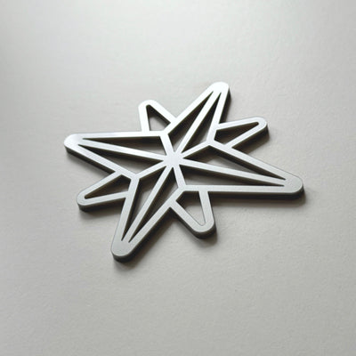 A silver star-shaped object is shown against a plain white background.