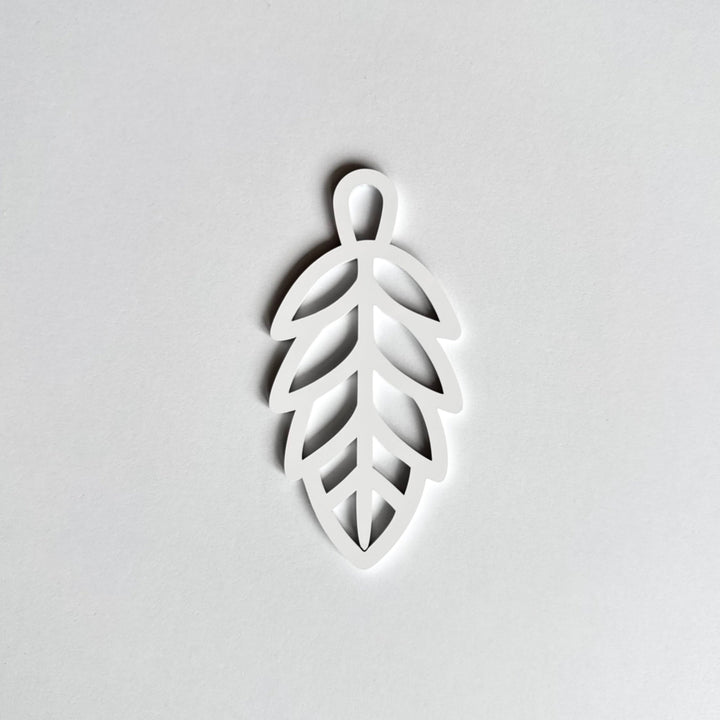 A white leaf-shaped object is shown against a plain white background.