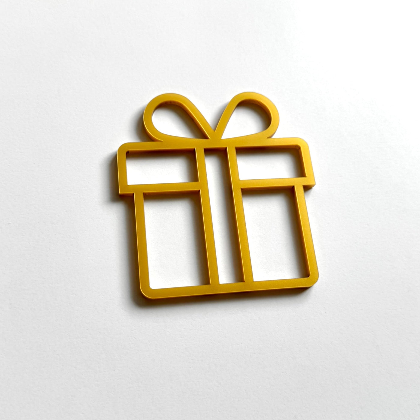 A golden gift box-shaped object is shown against a white background.