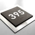 A black square sign with the number "395" printed on it. - Photo #3