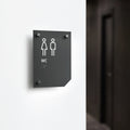 a black and white bathroom sign on a white wall - Photo #12