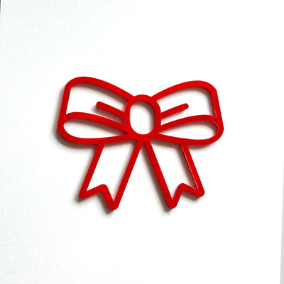 A red bow-shaped cutout is displayed against a white background.