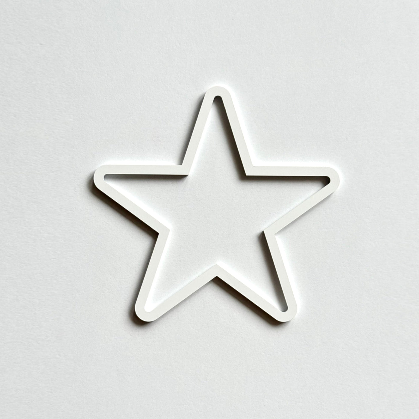 A white star shape is centered against a plain white background.