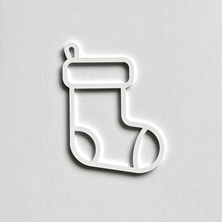 A simple white outline of a stocking on a plain white background.