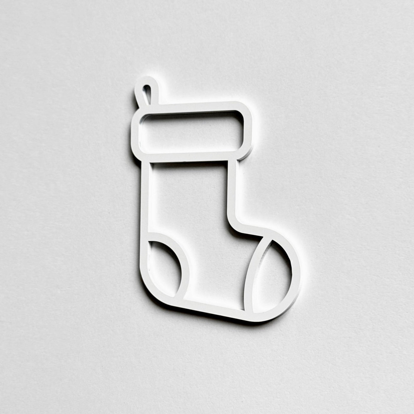 A simple white outline of a stocking on a plain white background.