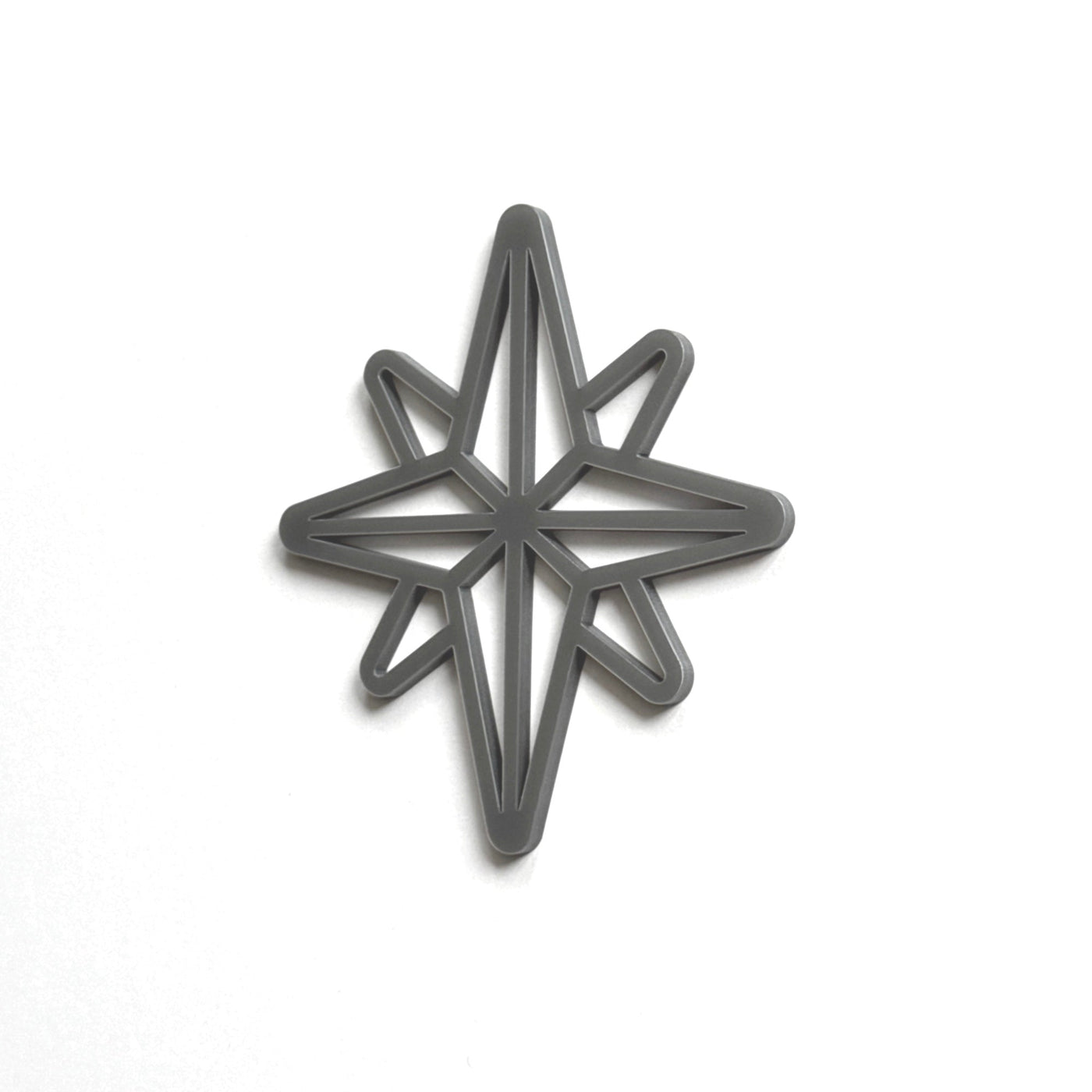 A black star-shaped cutout or stencil is shown against a white background.