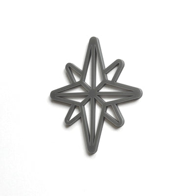 A black star-shaped cutout or stencil is shown against a white background.