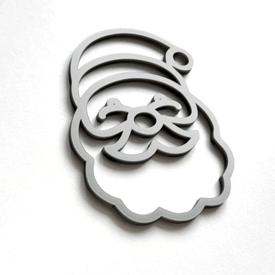 A stylized silhouette of a smiling face, resembling a cartoon or holiday-themed design, is shown against a plain white background.