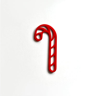 A red candy cane is shown against a white background.