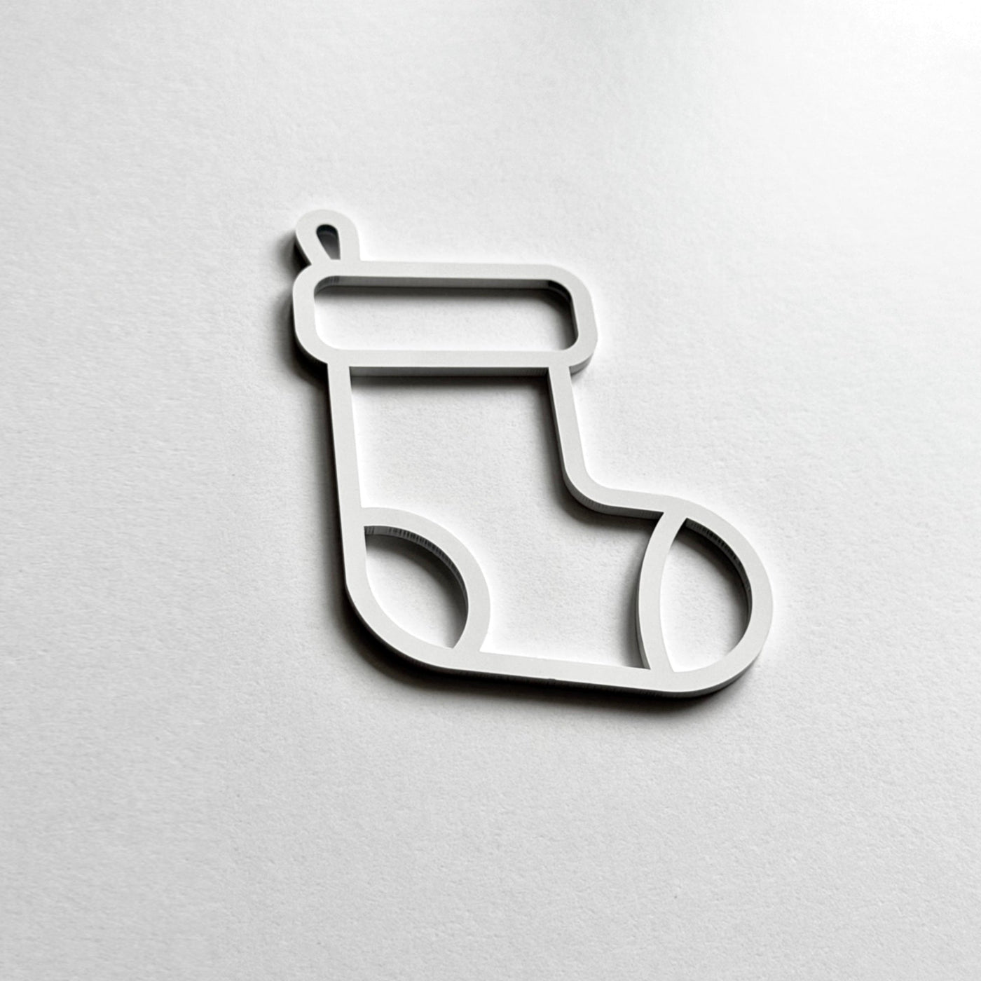 A simple white outline of a stocking on a plain white background.