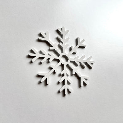 A white snowflake-shaped object is displayed against a plain white background.