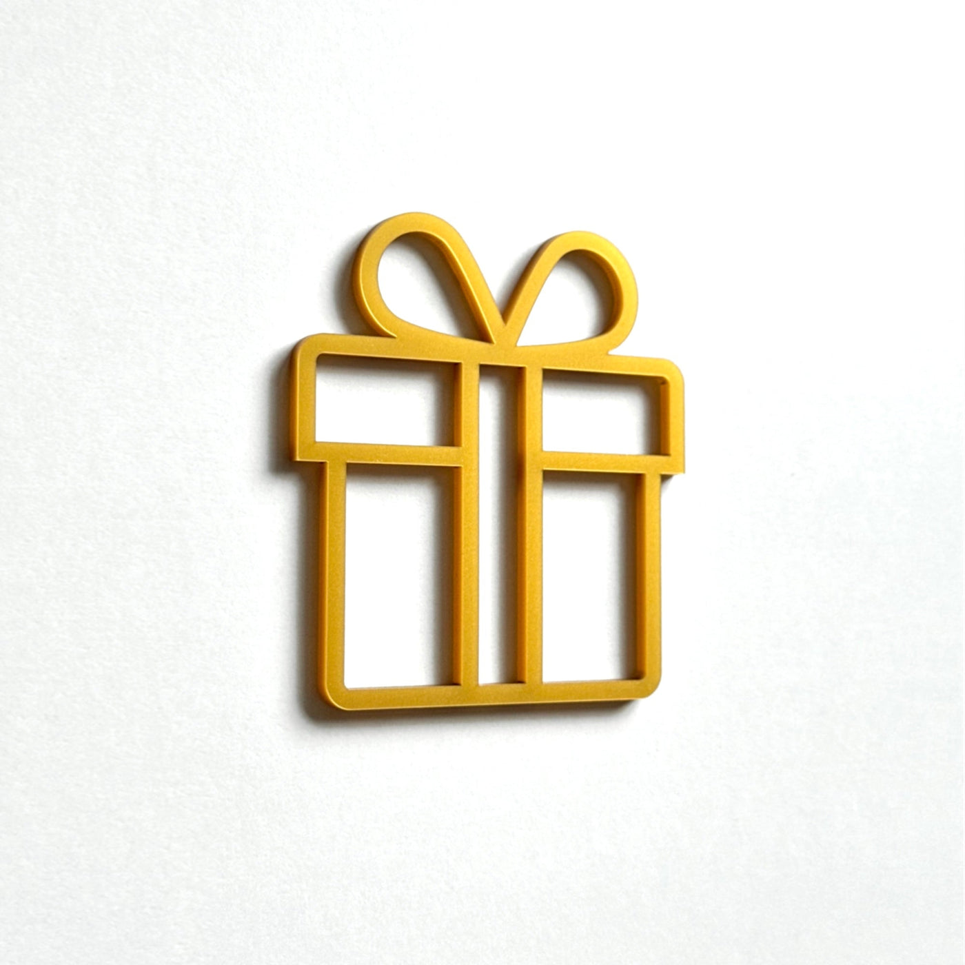 A simple gold-colored gift box icon is displayed against a white background.