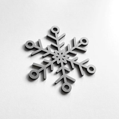 A silver snowflake ornament is displayed against a white background.