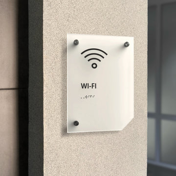 a white sign mounted to the side of a building - Photo #9