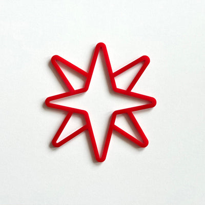 A red star-shaped object is centered against a white background.