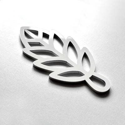 A 3D rendering of a stylized leaf-like shape in silver or metallic material.