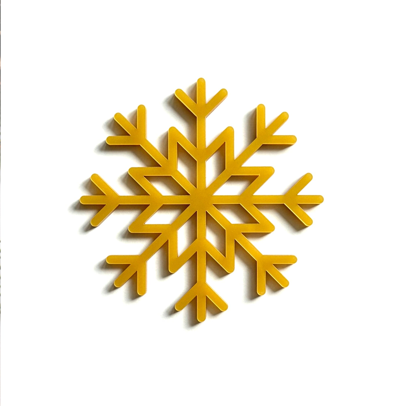 A golden snowflake-shaped object is displayed against a white background.