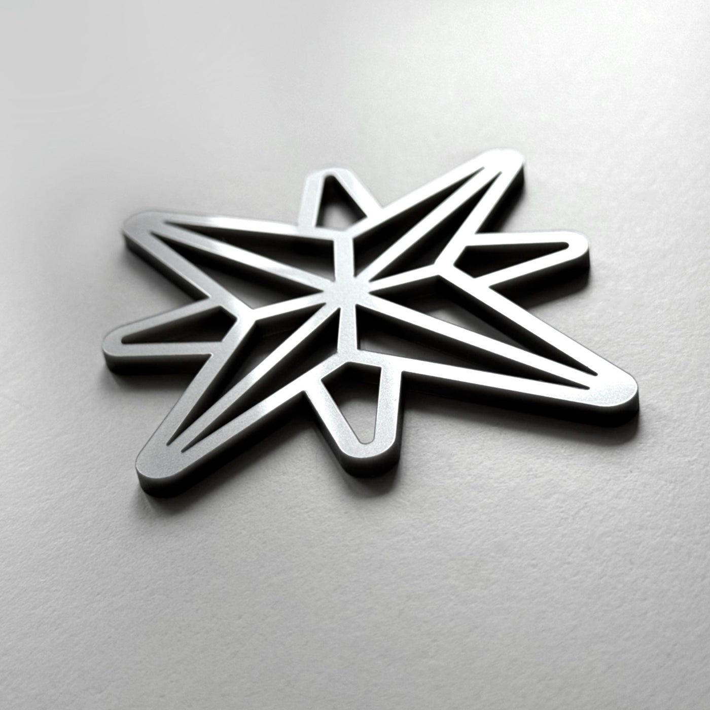 A metallic star-shaped object with a geometric design.